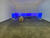 Ein leerer großes weißer Raum; drei Wände sind mit 8 blauen Rechtecken angebeamert, in der Mitte steht eine gelbe Kiste. Jason Hirata. Floaters, 2020. Galleria Fanta. Milano. Liste Art Fair. “Agreement, that a friendly entity loans their projectors for th