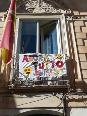 Banner mit der Aufschrift &quot;Andra tutto bene&quot; an einem Balkon in Italine.