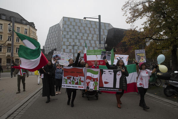 Demonstrationsfront mit Iran-Fahnen, Schildern und mehrheitlich weiblich gelesenen Demonstrant*innen. Im Hintergrund die UB, die Demo biegt offensichtlich in die Rempartstraße ein.