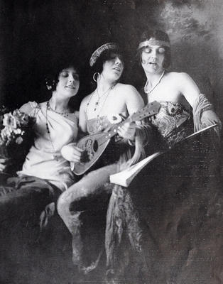 Three young women with instruments and a songbook (1915)