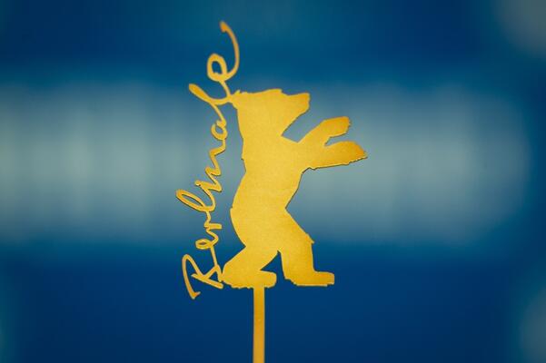 Logo der Berlinale: Der auf die Hinterbeine aufgerichtete Bär mit Schriftzug &quot;Berlinale&quot; links von unten nach oben gelb auf blauem Hintergrund