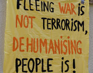 Banner: "Fleeing War is not Terrorism, dehumanising people is!"