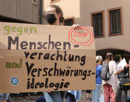 Ein Schild mit dem Slogan "Gegen Menschenverachtung und Verschwörungsideologie"